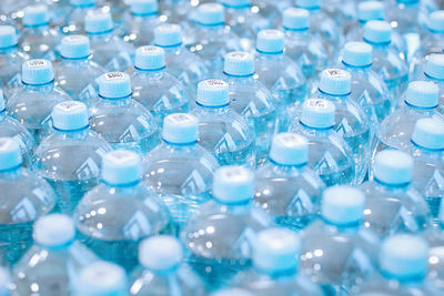 Drinking water in plastic bottles in the grocery store, recyclable packaging