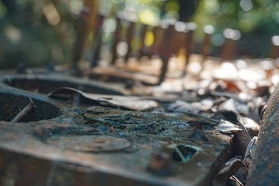 Close-up of old metal structure on field