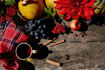 Rustic cozy still life  grapes, viburnum, corn, pumpkin melon, apples. cozy home, warm cup of tea. 