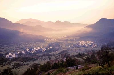 Scenic view of mountains against sky at sunset