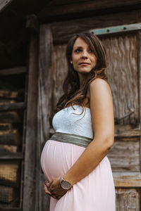 Pregnant woman standing in park