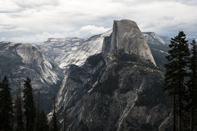 Scenic view of mountain range against cloudy sky