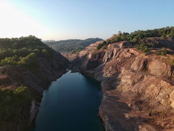 Scenic view of river amidst mountains against clear sky