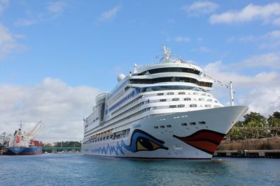 Ship moored at harbor against sky