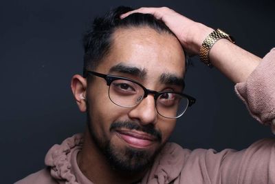 Portrait of mature man wearing hat against black background