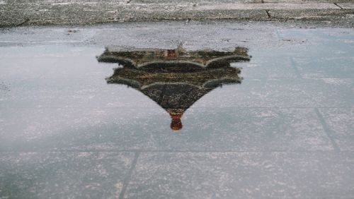 High angle view of puddle on street during winter