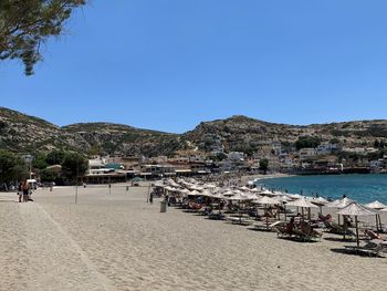 Scenic view of beach against clear blue sky