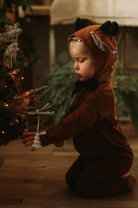 Side view of girl with christmas tree