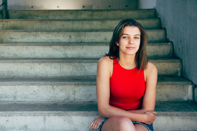 Portrait of woman sitting on staircase