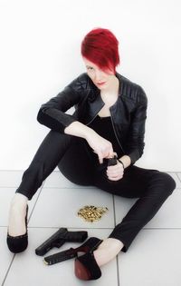 Portrait of young woman holding white background