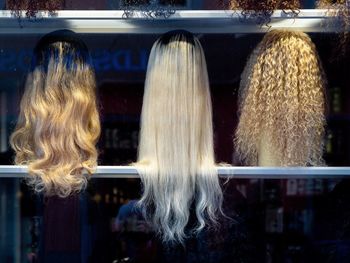 Rear view of woman standing by display at store
