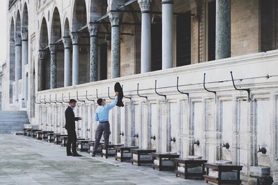 People in front of built structure