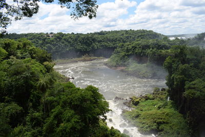 Scenic view of waterfall against sky
