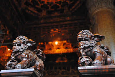 Close-up of statue against illuminated temple