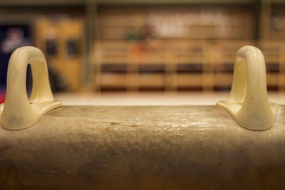 Close-up of lamp on table against wall