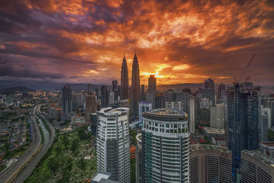 Aerial view of buildings in city during sunset