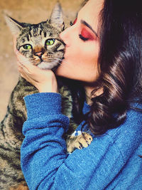 Portrait of  young woman with green eyes cat