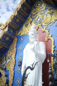 Statue of buddha against building