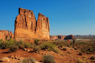 Rock formations on landscape against clear sky