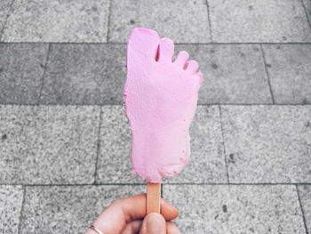 Close-up of hand holding ice cream cone