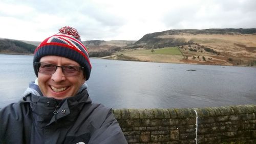 Portrait of smiling man standing in snow