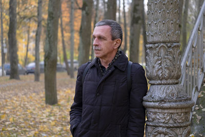 Portrait of young man standing in park