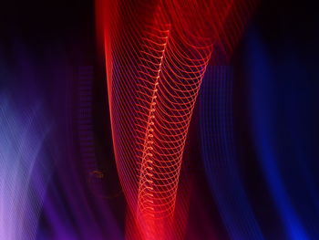 Close-up of illuminated light painting against black background