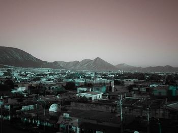 High angle shot of townscape against sky at dusk