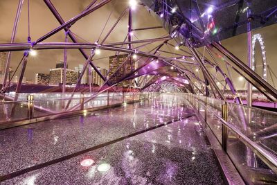 Illuminated bridge in city at night