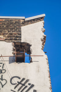 Low angle view of built structure against clear blue sky