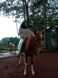 Full length of man riding horse