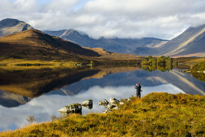 Scenic view of lake and mountains against sky