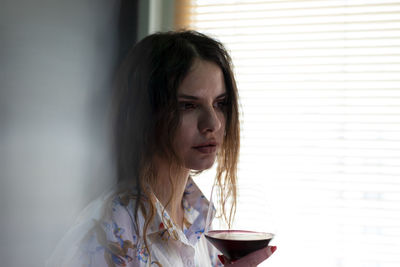 Woman drinking wine at home