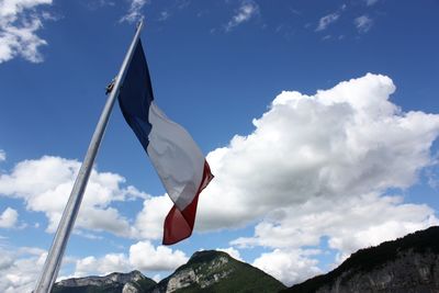 Low angle view of flag flags against sky