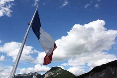 Low angle view of flag flags against sky