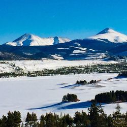 Scenic view of snowcapped mountain against blue sky