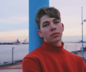 Portrait of young man standing against sky during sunset