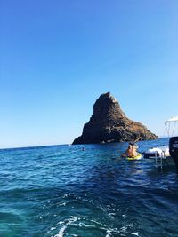 Scenic view of sea against clear blue sky