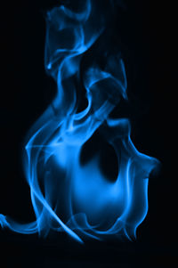 Close-up of blue flame against black background