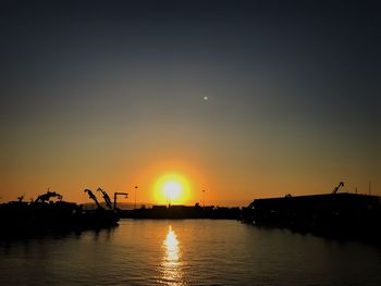 Scenic view of river against sky during sunset