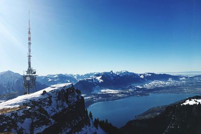 Scenic view of snowcapped mountains against clear blue sky