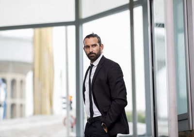 Man standing in front of office building