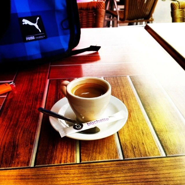 drink, coffee cup, table, coffee - drink, food and drink, refreshment, indoors, saucer, coffee, wood - material, cup, high angle view, still life, freshness, tea cup, spoon, beverage, wooden, wood, tea