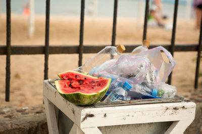 Close-up of garbage bin against built structure