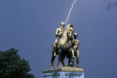 Low angle view of statue against sky