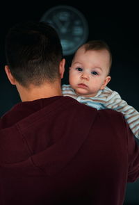 Father carrying his little baby who can't sleep at about 1 am