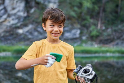 Portrait of smiling boy holding water