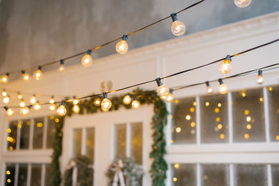 Retro christmas garland on the background of the white entrance doors to the house. selective focus