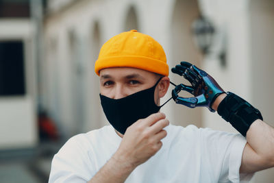 Midsection of man wearing hat