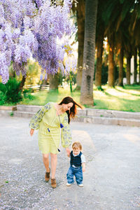 Full length of women standing by tree